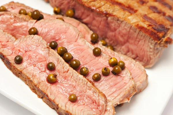 Sliced steak on a plate — Stock Photo, Image