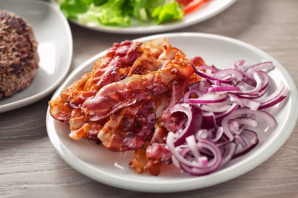 Bacon and Onions on plate — Stock Photo, Image