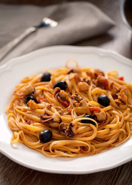 Pasta with octopus and olives — Stock Photo, Image