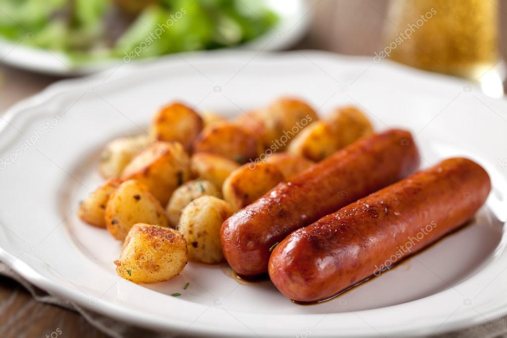 Sausages and potatoes on plate