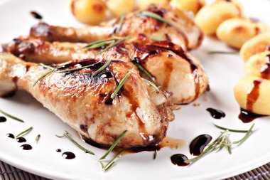 Roast chicken with potatoes on a plate clipart
