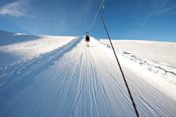 Person on ski lift in mountains — Stock Photo, Image