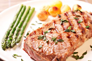 Steak with asparagus and potateos clipart