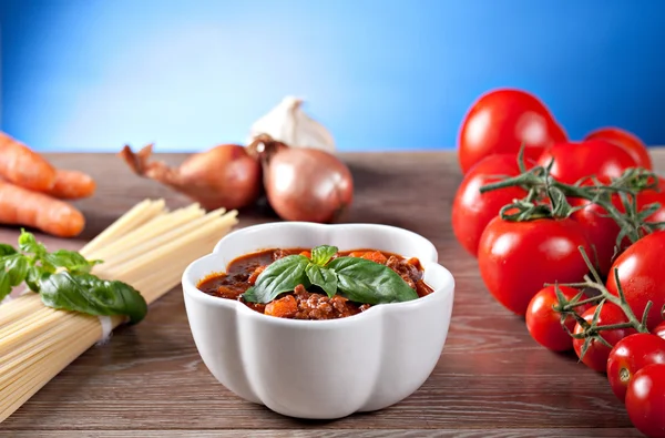 Bolognese sauce and different ingredients — Stock Photo, Image
