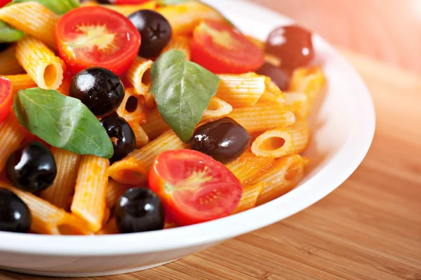 Pasta with tomato sauce and olives — Stock Photo, Image