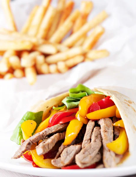 Fajitas with fries on plate — Stock Photo, Image