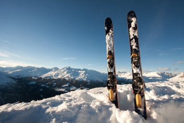 Skis in snow in mountains clipart