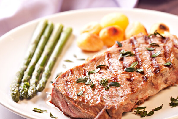 Delicious Steak with asparagus, close up