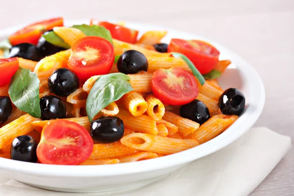Pasta with tomato sauce and olives — Stock Photo, Image