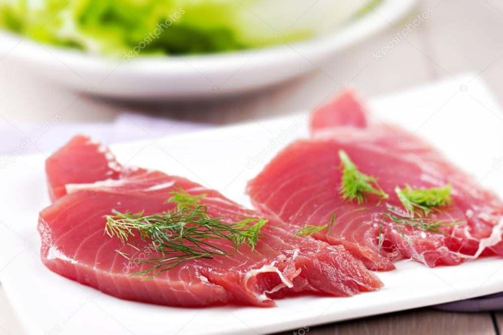 Raw sliced tuna and greens