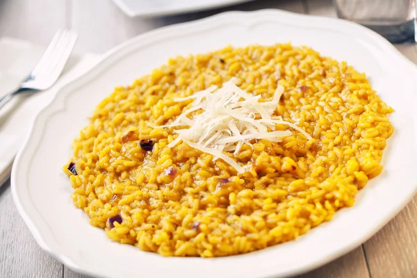 Risotto Zafferano on white plate Stock Picture