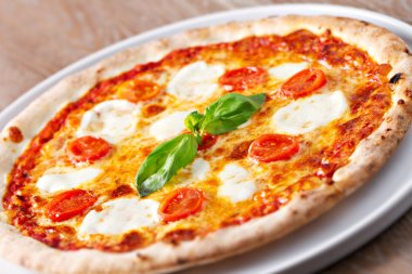 pizza margherita on table clipart