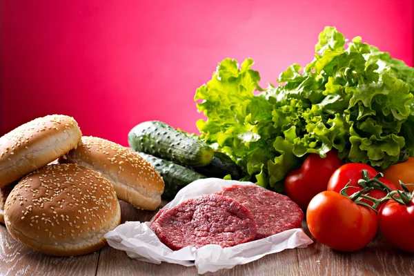 Ingredients for hamburgers on table — Stock Photo, Image