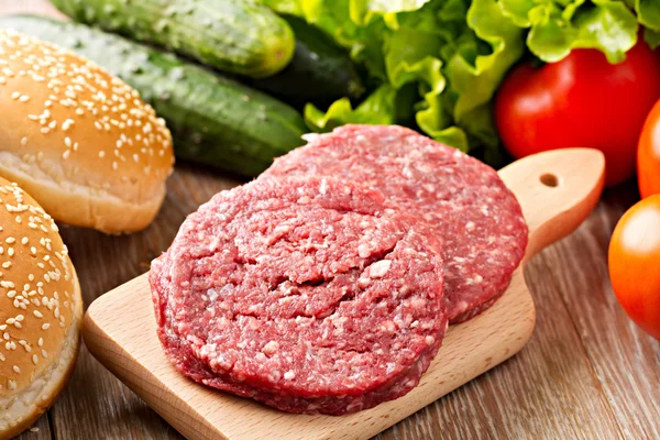 Ingredients for hamburgers on table — Stock Photo, Image