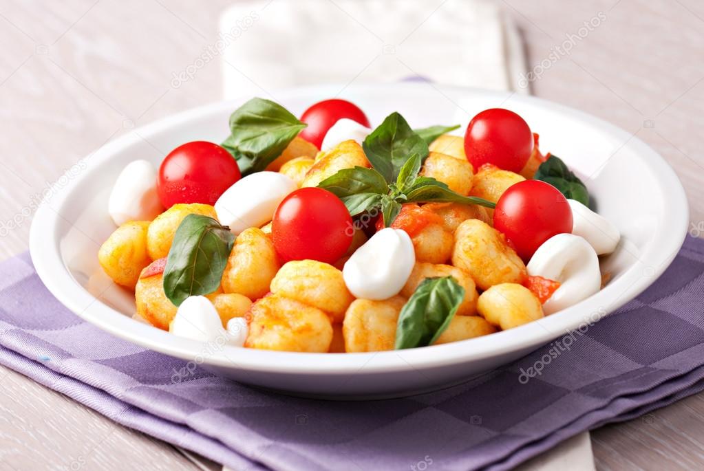 Gnocchi with tomatoes mozzarella and basil