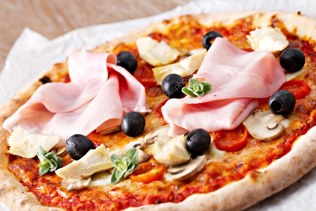 Pizza with olives, ham and mushrooms