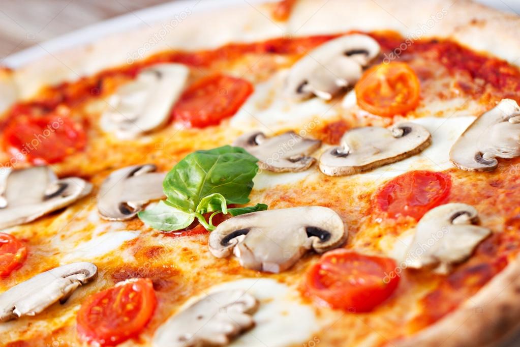 pizza with mushrooms on table