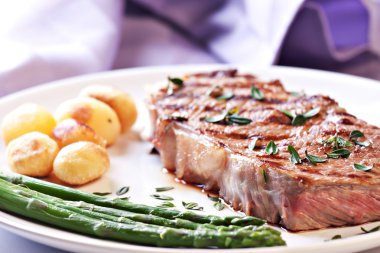 Steak with asparagus and potateos clipart