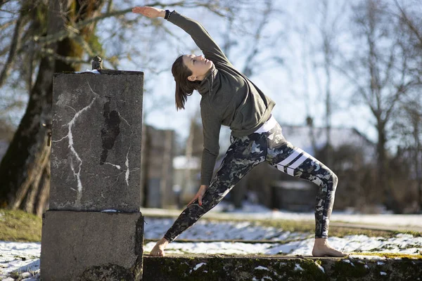 Yoga outdoor. Happy woman doing yoga exercises. Yoga meditation in nature. Concept of healthy lifestyle and relaxation.