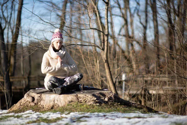 Yoga outdoor. Happy woman doing yoga exercises. Yoga meditation in nature. Concept of healthy lifestyle and relaxation.