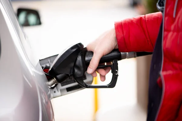 man\'s hand is refuelling gas or oil in the refuelling station prepare transport to travel