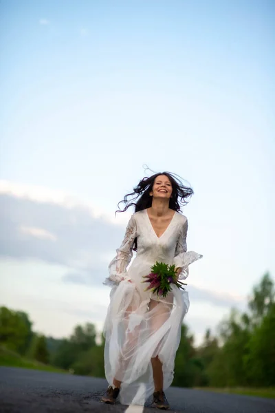 Funny Young Woman White Dress Jumping Empty Asphalt Road — Stockfoto