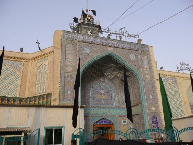 Najaf, Iraq - april 27, 2015:  photos of the holy rilic imam ali in najaf city clipart
