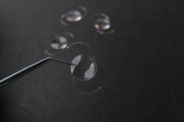 closeup photo of elastic intra ocular lens for cataract surgery