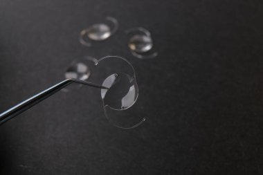 closeup photo of elastic intra ocular lens for cataract surgery