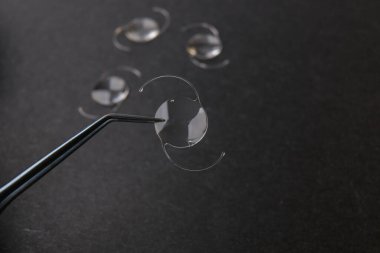 closeup photo of elastic intra ocular lens for cataract surgery