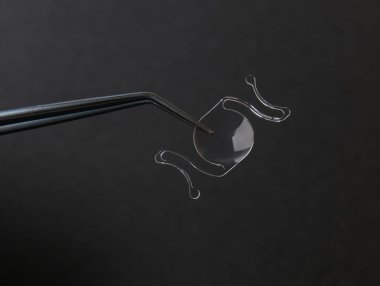 closeup photo of elastic intra ocular lens for cataract surgery