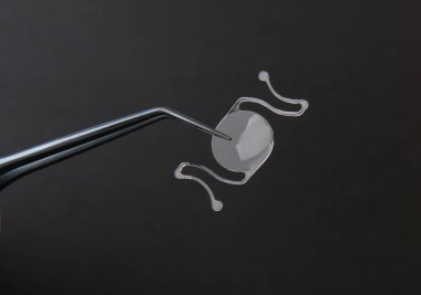 closeup photo of elastic intra ocular lens for cataract surgery