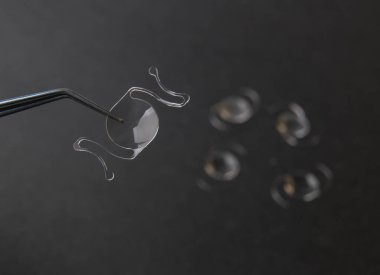 closeup photo of elastic intra ocular lens for cataract surgery