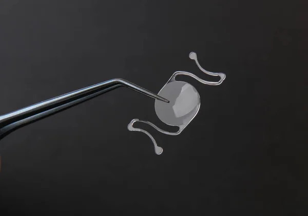 closeup photo of elastic intra ocular lens for cataract surgery