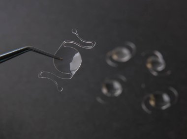 closeup photo of elastic intra ocular lens for cataract surgery