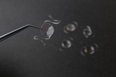 closeup photo of elastic intra ocular lens for cataract surgery