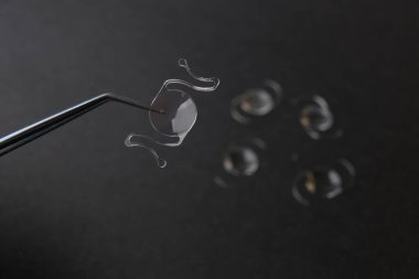 closeup photo of elastic intra ocular lens for cataract surgery
