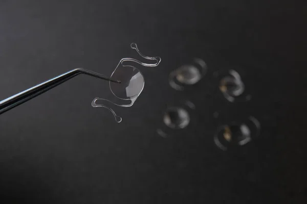 closeup photo of elastic intra ocular lens for cataract surgery