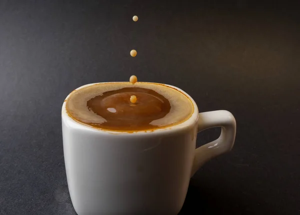 closeup photo of coffee drop in a cup