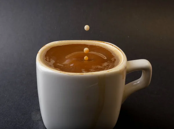 closeup photo of coffee drop in a cup