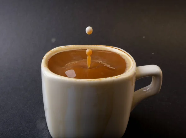 closeup photo of coffee drop in a cup