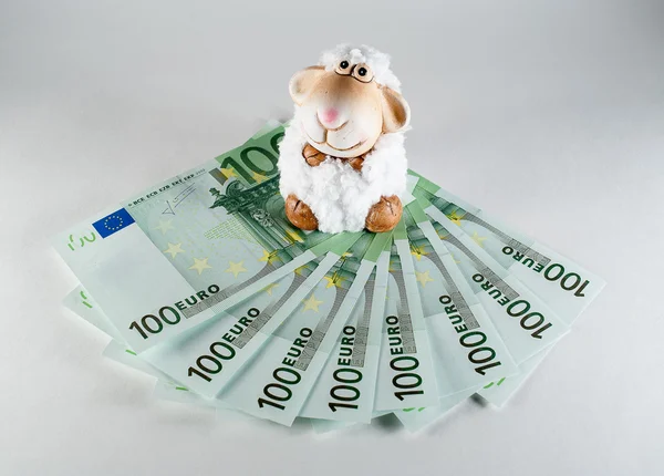 Toy sheep on banknotes 100 euro — Stock Photo, Image