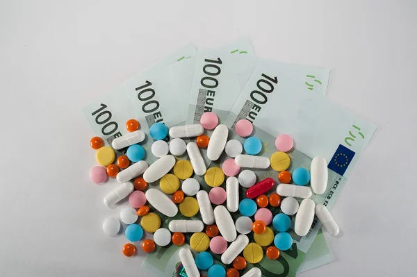 Medicines, tablets on the banknotes of 100 euros — Stock Photo, Image