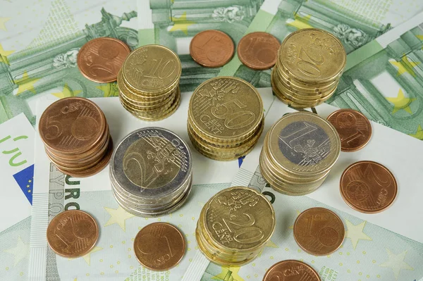 Stack of Euro coins to banknotes 100 Euro — Stock Photo, Image