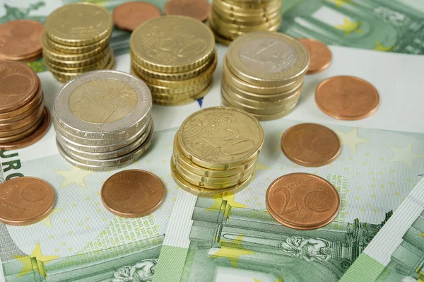 Stack of Euro coins to banknotes 100 Euro — Stock Photo, Image