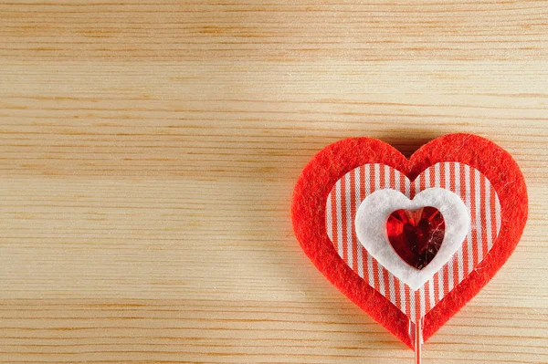 The heart of felt on wooden background — Stock Photo, Image