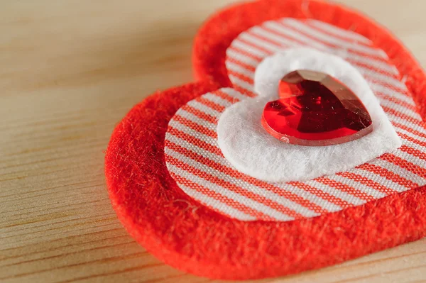 The heart of felt on wooden background — Stock Photo, Image