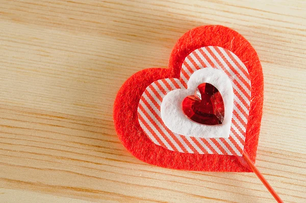 The heart of felt on wooden background — Stock Photo, Image