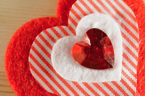 The heart of felt on wooden background — Stock Photo, Image