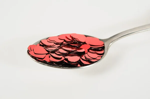 Confetti of hearts in a spoon — Stock Photo, Image